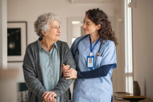 nursing home caregiver helps senior women