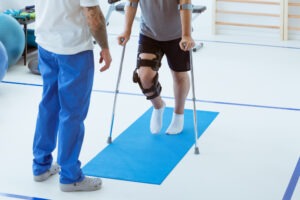 Man on crutches after an accident. Discover how a personal injury attorney in Eutaw can help you recover compensation.