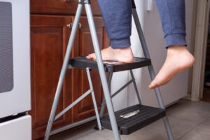 person stands on step stool involved in product liability suit