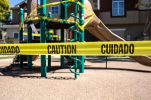 Yellow caution tape around the playground in premises liability case.