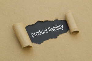 Paper torn to reveal the words ‘product liability.’ Find out how to build a claim with an Atlanta product liability lawyer.