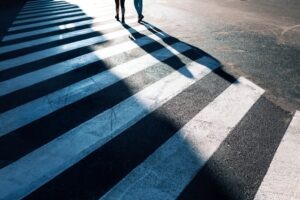 Shadow of a pedestrian on a crosswalk in Eutaw.