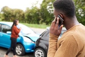 A man calling a Georgia car accident lawyer after a collision.